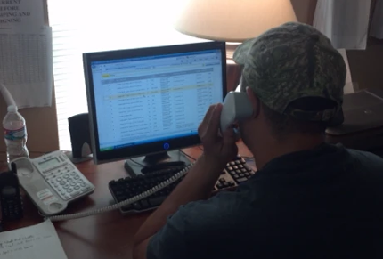 Old damaged vehicle with vintage television set on rough pathway under bridge in sunlight