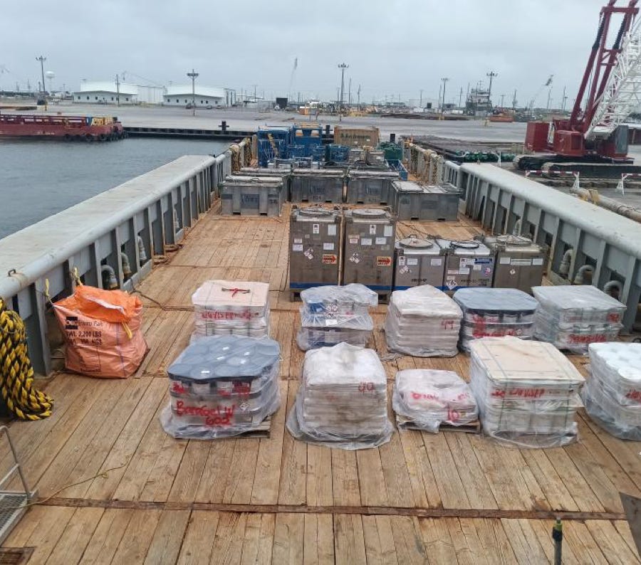 A man standing on a street with a skateboard